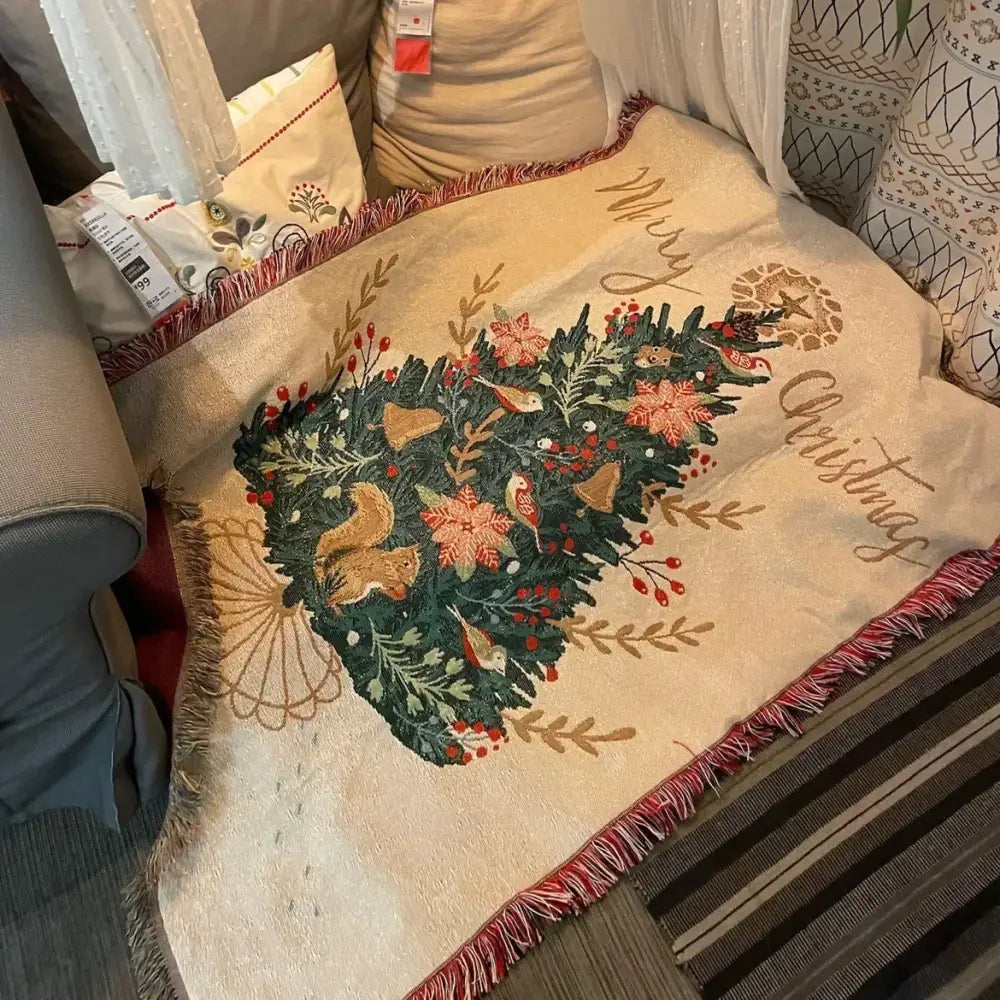 Beige decorbites christmas throw blanket with embroidered green foliage red berries golden bells and squirrels with red fringe
