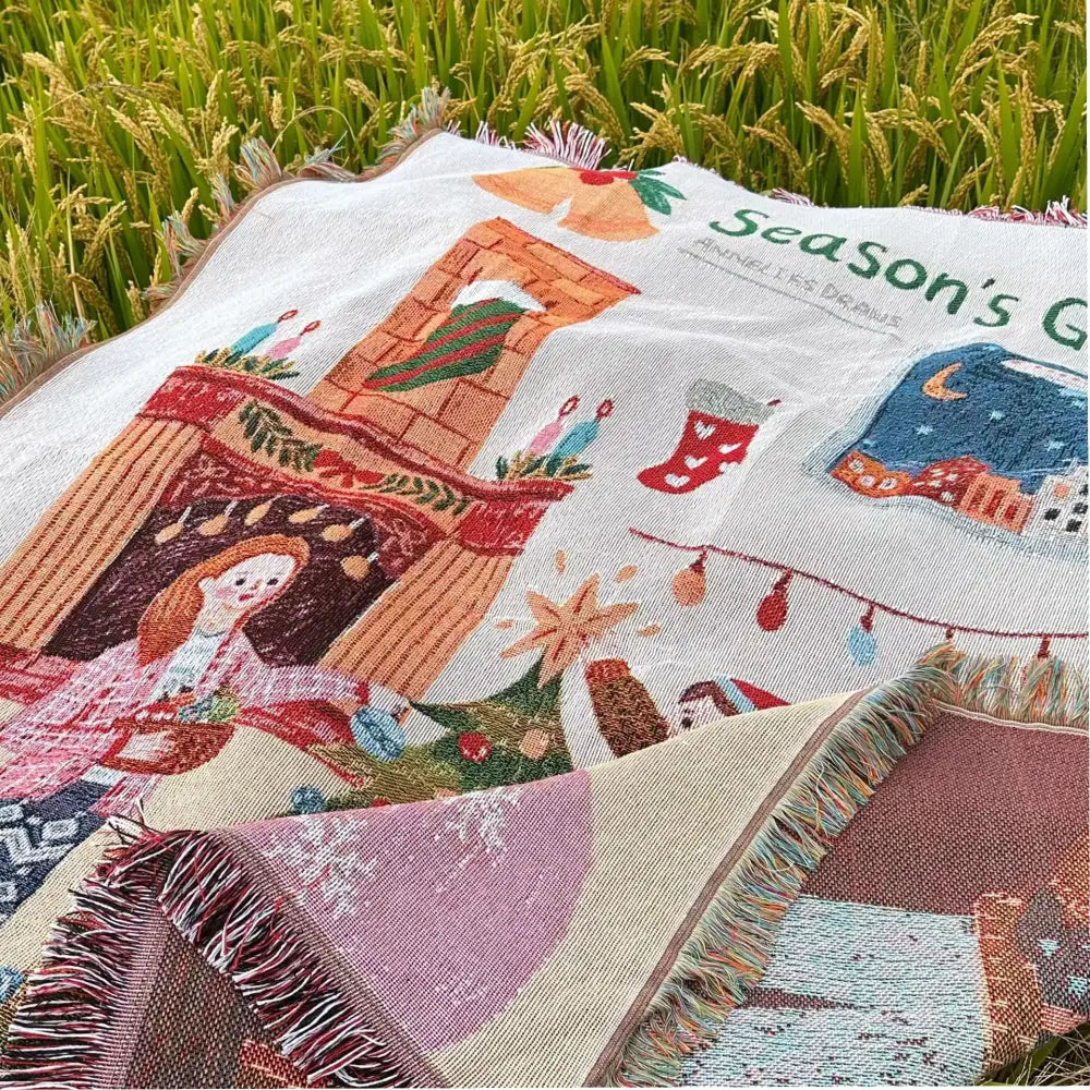 A cozy multicolored woven decorbites christmas tree blanket with festive illustrations and fringed edges for home use