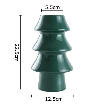 A glossy dark green ceramic vase shaped like a tiered christmas tree from decorbites christmas tree collection
