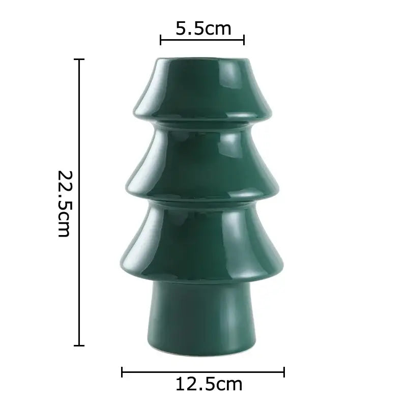 A glossy dark green ceramic vase shaped like a tiered christmas tree from decorbites christmas tree collection