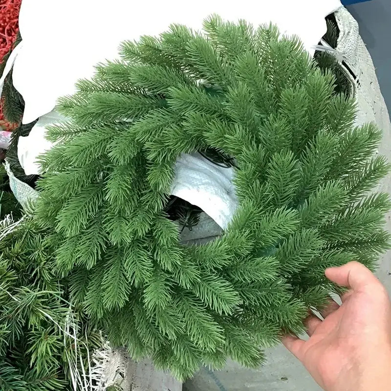 A lush artificial green pine wreath with dense needle-like foliage for decorbites christmas tree decor suspension