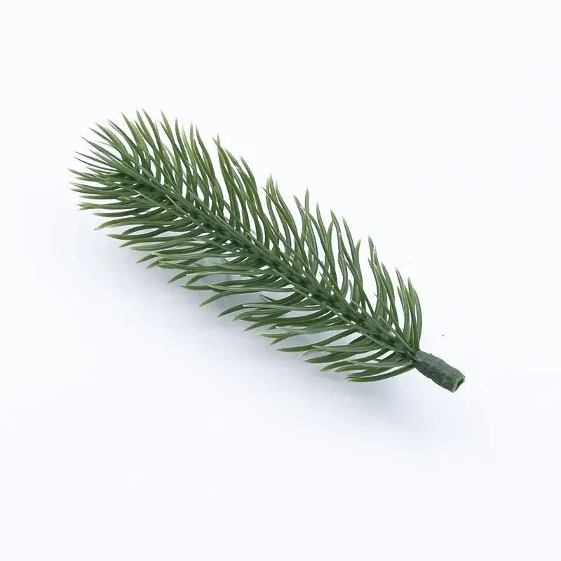 A synthetic green pine branch with detailed needle-like foliage and textured stem for decorbites christmas tree decor