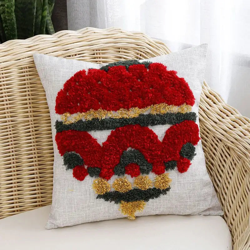 Square pillow cover with red and gold textured pom-poms on light gray linen for decorbites christmas tree gold decor