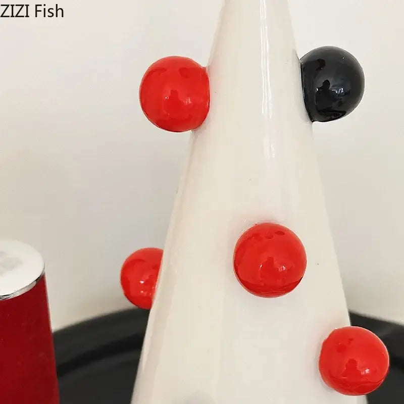 White ceramic decorbites christmas tree jewelry stand adorned with glossy red and black beads for earring storage