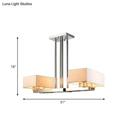 Modern chrome pendant light with two rectangular beige fabric shades designed for dining room use by decorbites