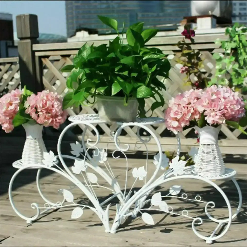 White wrought iron classic tall plant stand with leaf and vine scrollwork for indoor and outdoor use