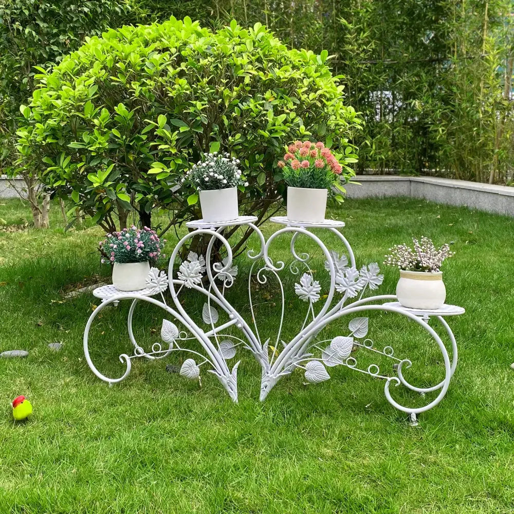 White wrought iron classic tall plant stand with floral and leaf motifs for indoor and outdoor use by DecorBites