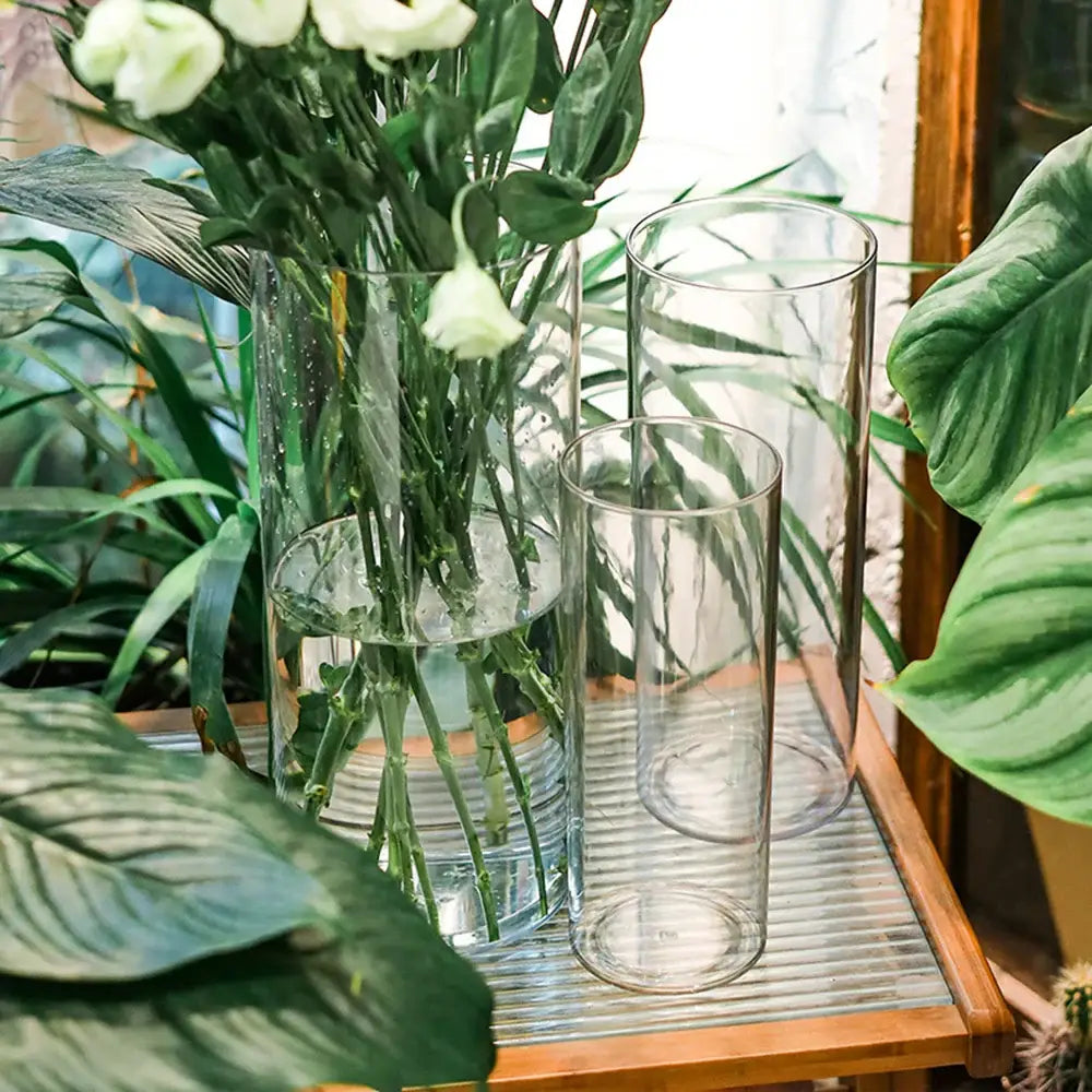 DecorBites™ clear acrylic cylinder vases of varying heights with white flowers, ideal for weddings and decor