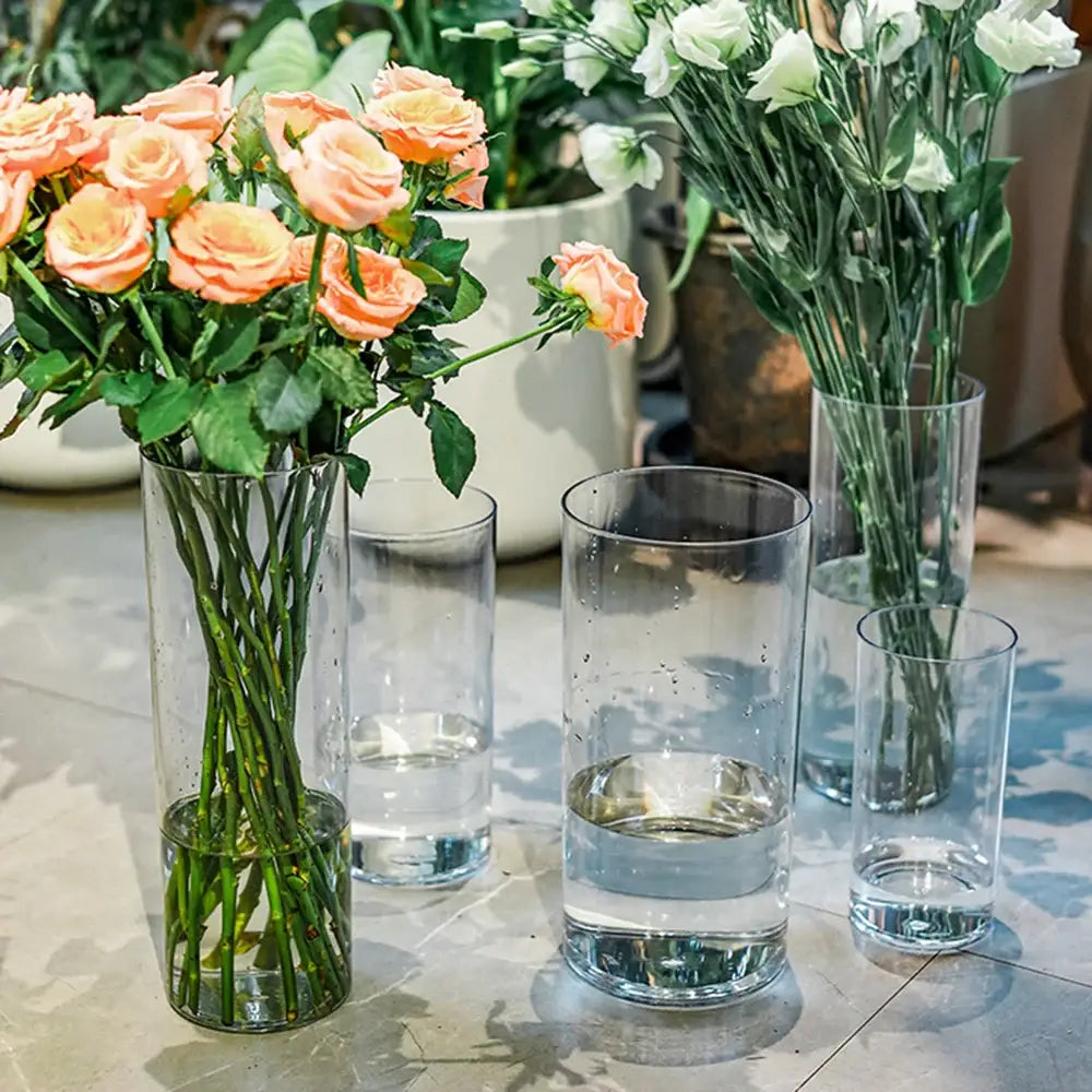 DecorBites™ clear acrylic hurricane flower vase set features large clear cylindrical vases with peach roses and water