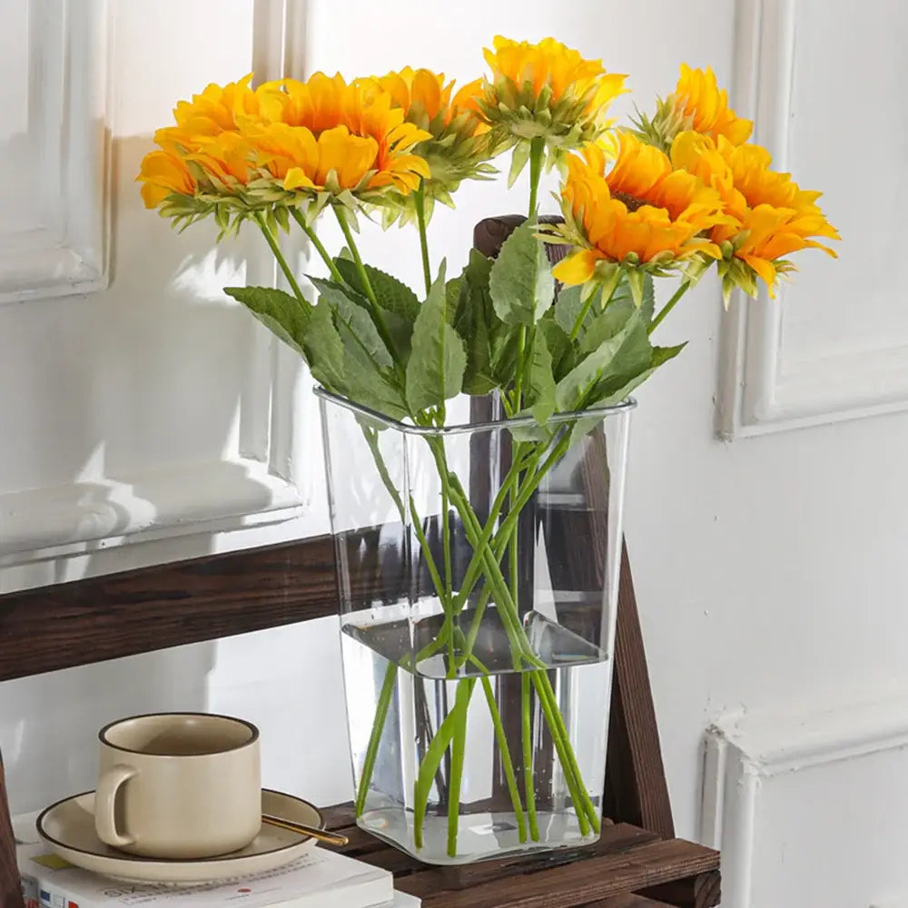 DecorBites clear acrylic hurricane flower vase large size with vibrant yellow sunflowers and green stems in a glass container