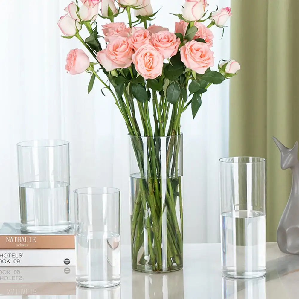 Tall clear acrylic hurricane flower vase by decorbites holding a bouquet of pink roses large size