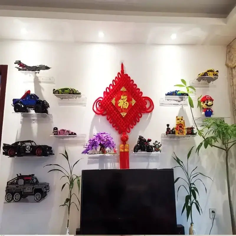 Red knotted chinese decorative knot with gold characters and tassels displayed on a wall mounted acrylic shelf organizer