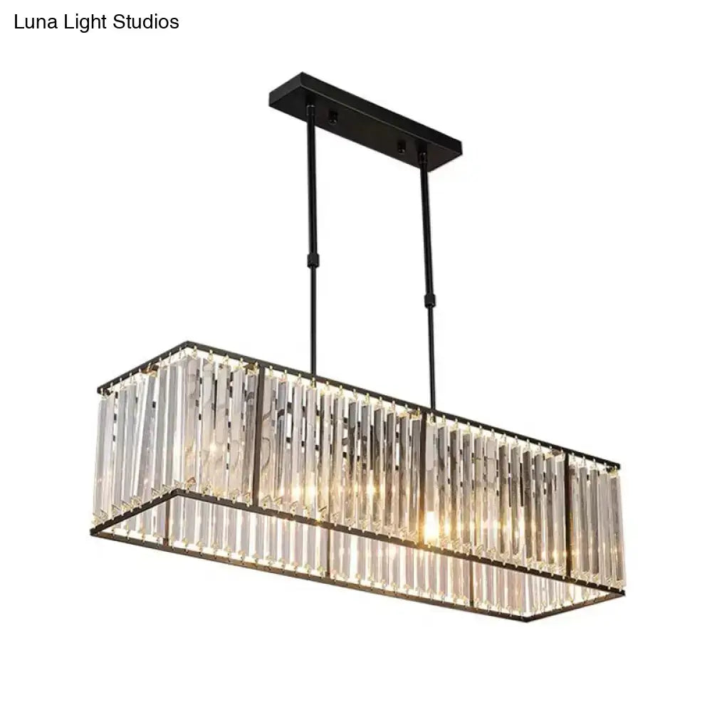 Decorbites clear crystal island pendant light with black metal frame and vertical crystal rods refracting warm light