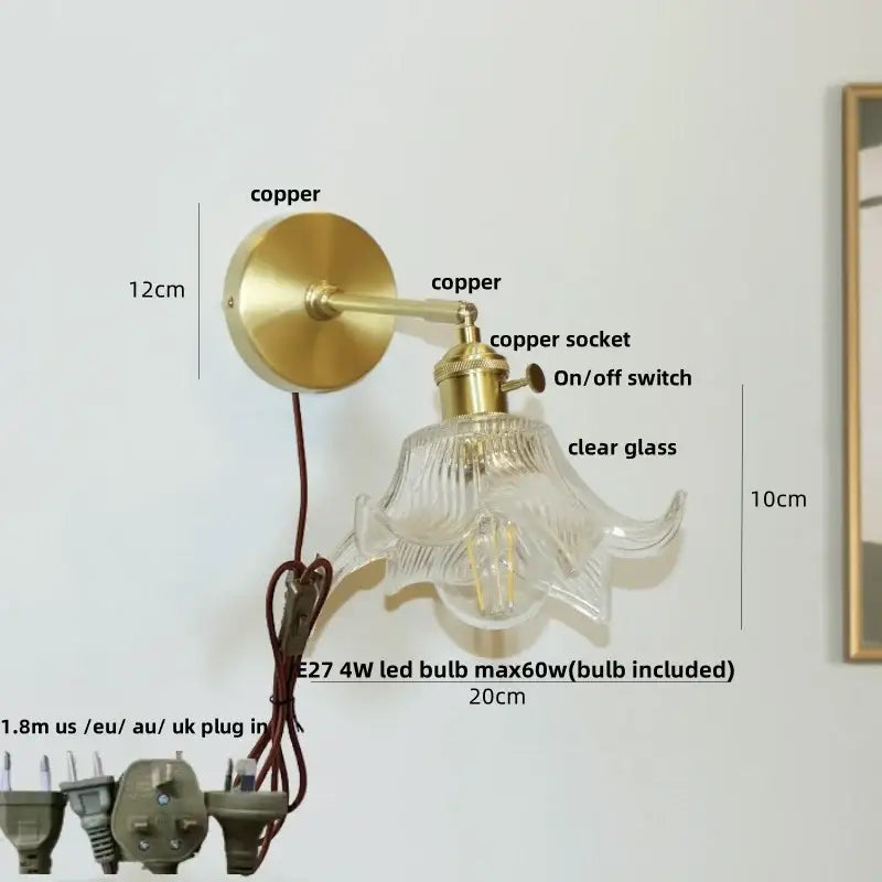 A vintage-style decorbites clear flower glass wall lamp with brass copper finish and clear glass shade for bedroom use
