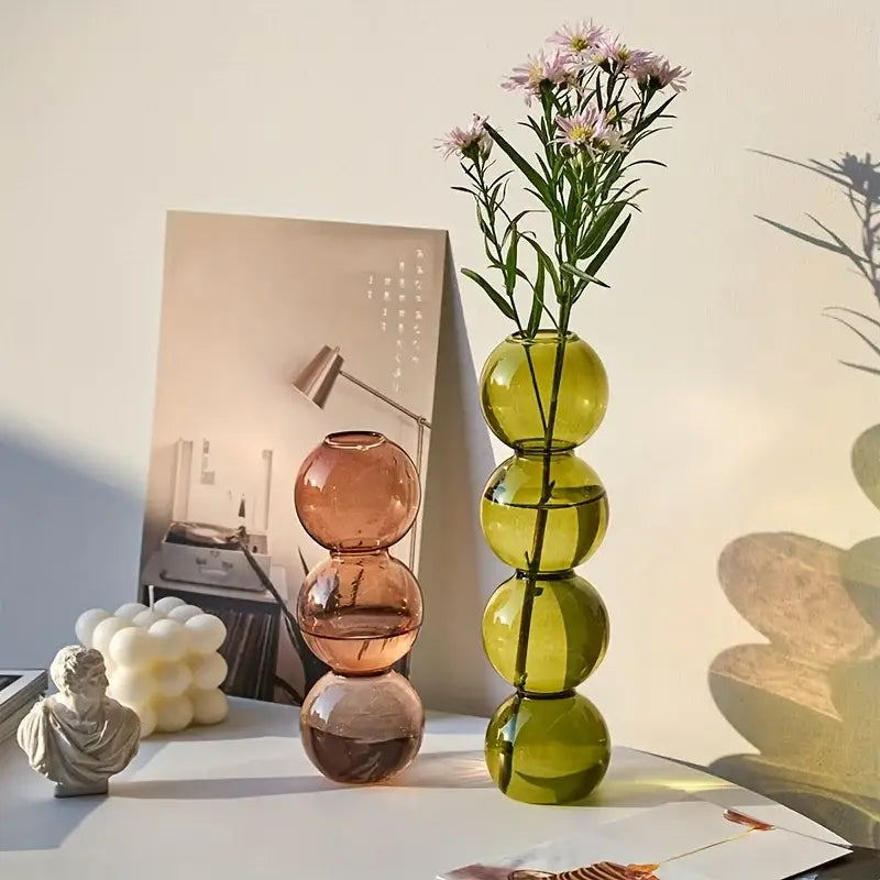 DecorBites clear glass bubble vase in translucent green with stacked spheres holding purple flowers for home decor