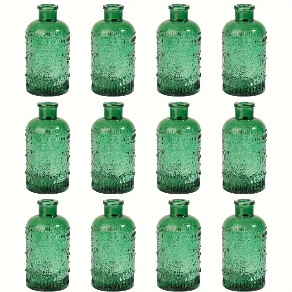 Set of twelve decorbites clear glass bud vases in emerald green with intricate embossed circular and beaded patterns