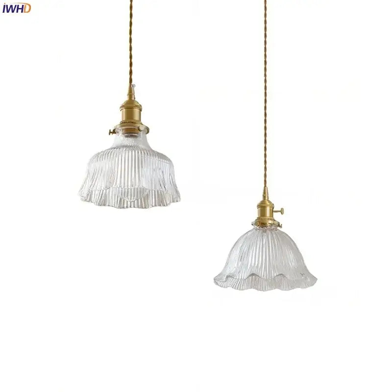 Two elegant decorbites clear glass led pendant lights with brass fixtures and twisted cords for bedroom use