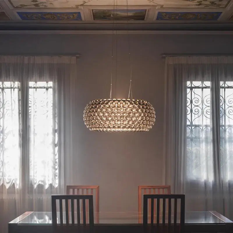 A decorbites clear gold acrylic pendant light with a golden spherical chandelier made of interlocking glass orbs for living room