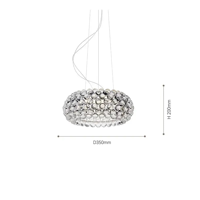 A modern circular pendant light fixture with clear glass orbs in decorbites clear gold acrylic for living rooms