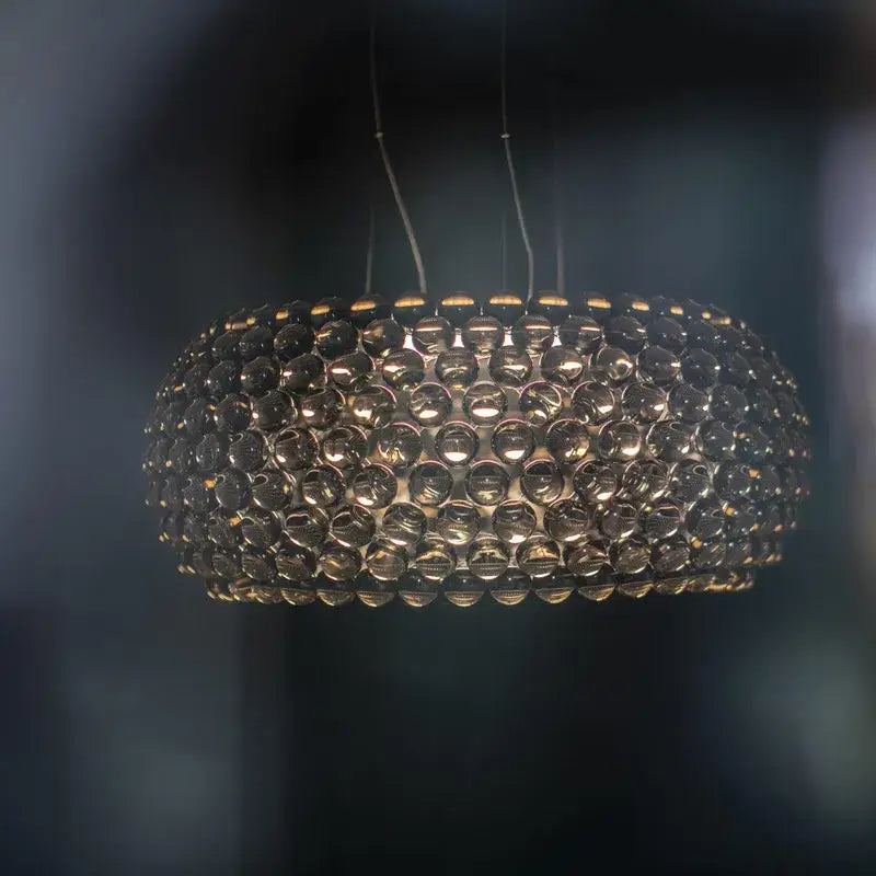 A modern spherical pendant light with clear gold acrylic orbs in a bubble pattern from decorbites pendant lights
