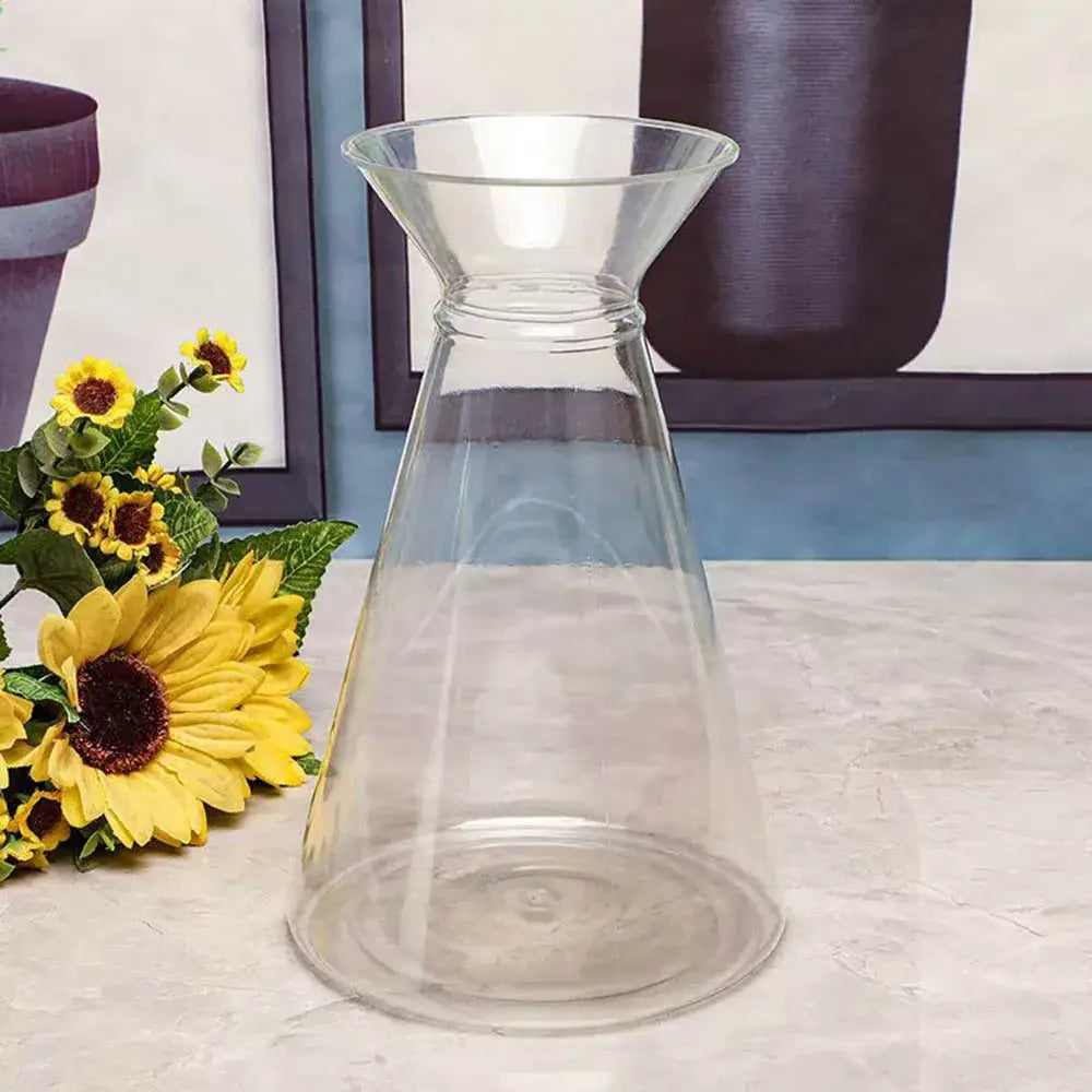 Clear glass carafe styled as a clear nordic plastic vase for hydroponic flowers with a flared top and tapered base