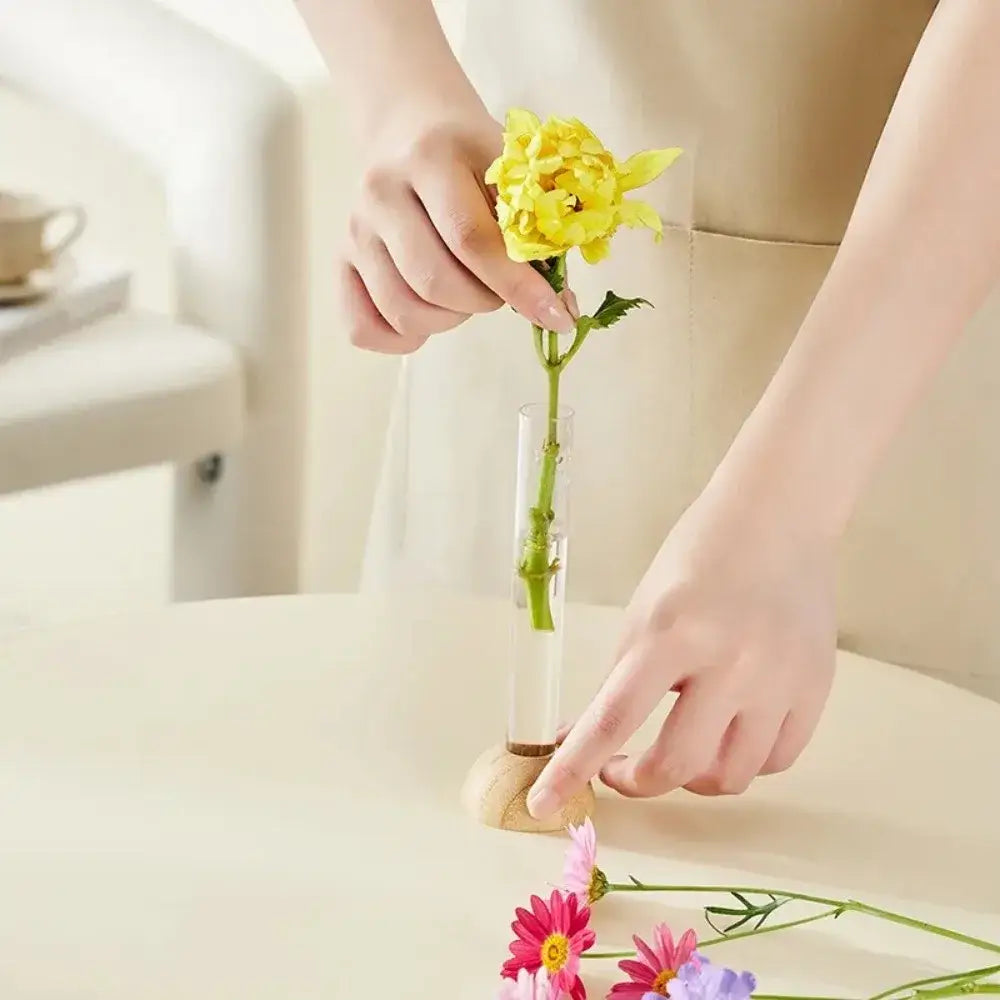 Decorbites clear plastic test tube vase with wooden base holding single yellow flower for home decor