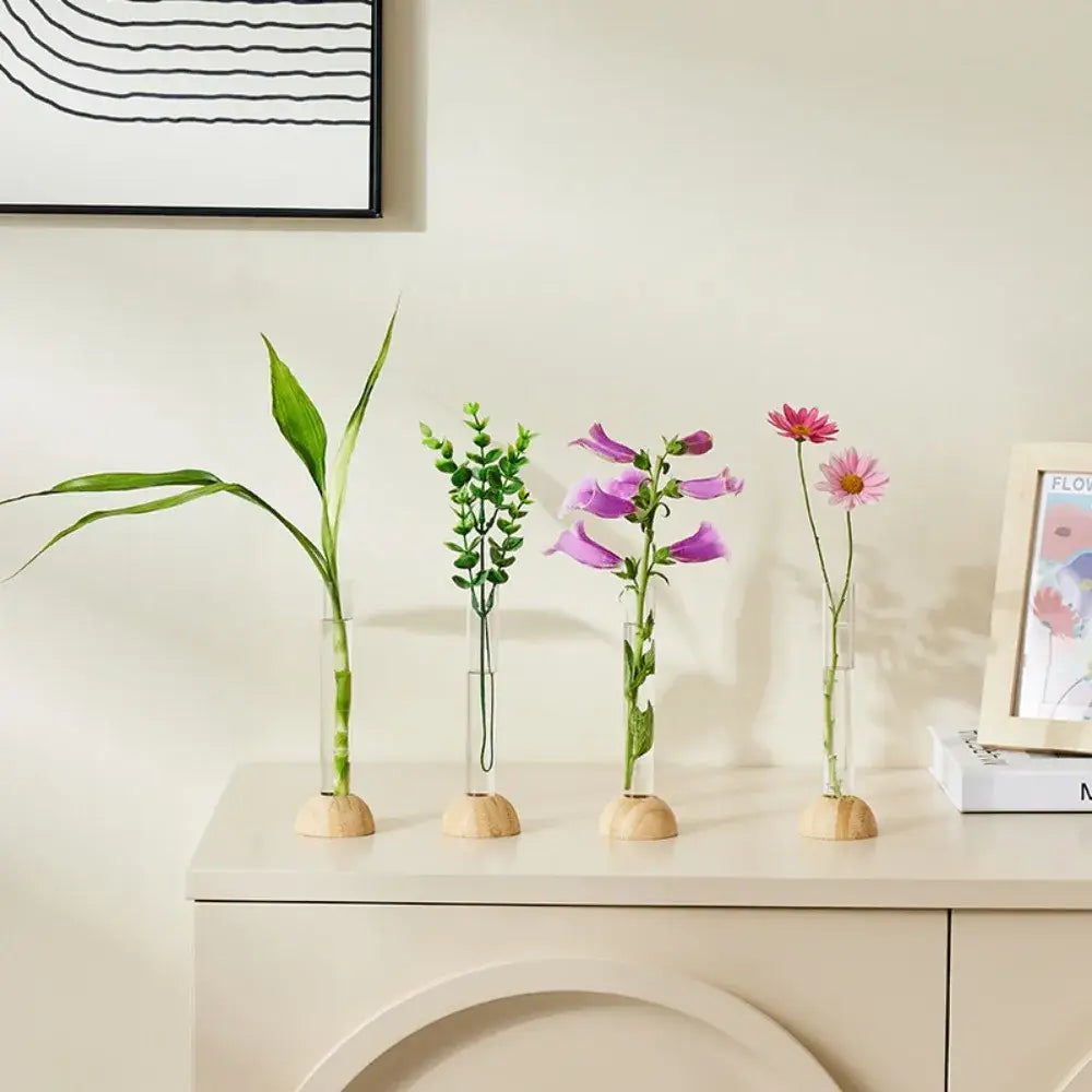 Four clear vases with bamboo base holding various plants in decorbites hydroponic vase tabletop decoration