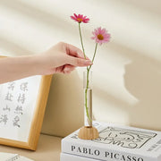 DecorBites clear vase with bamboo base holding two pink daisies as a hydroponic vase tabletop decoration
