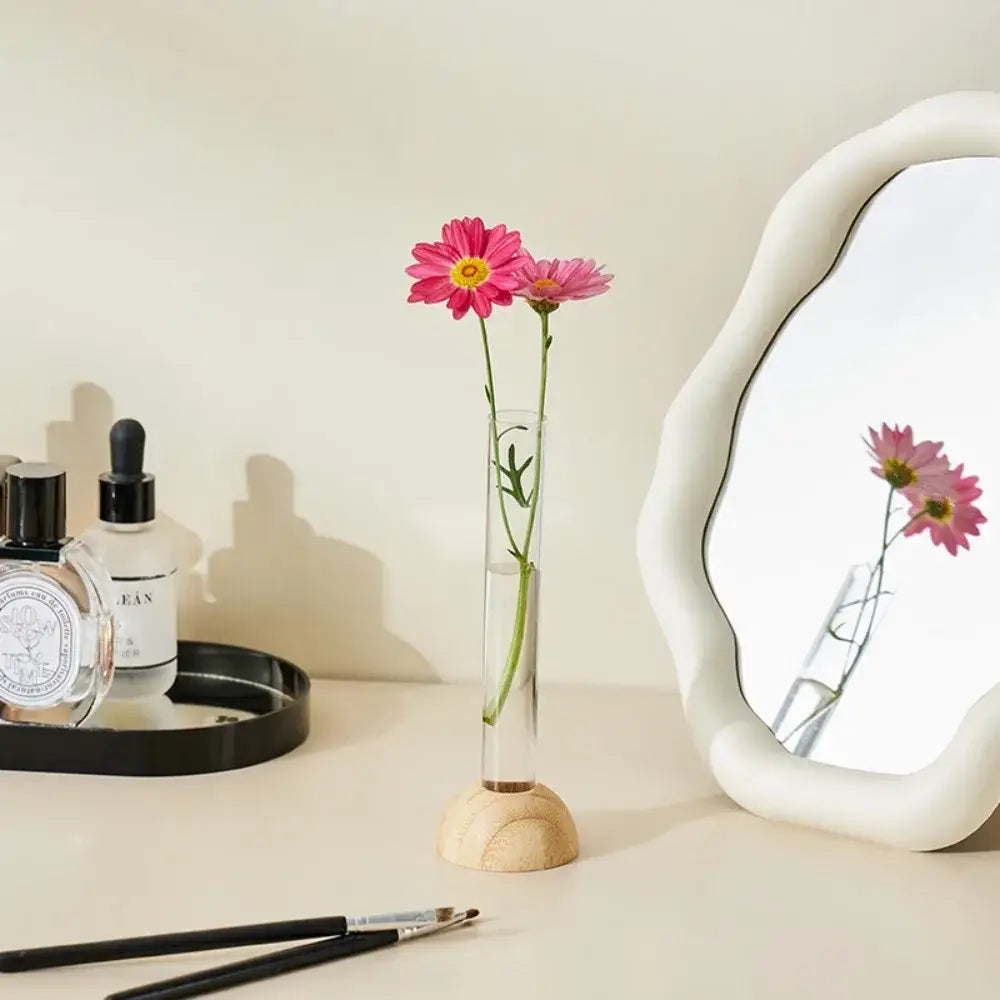 DecorBites clear vase with bamboo base holding two pink daisies as a hydroponic vase tabletop decoration