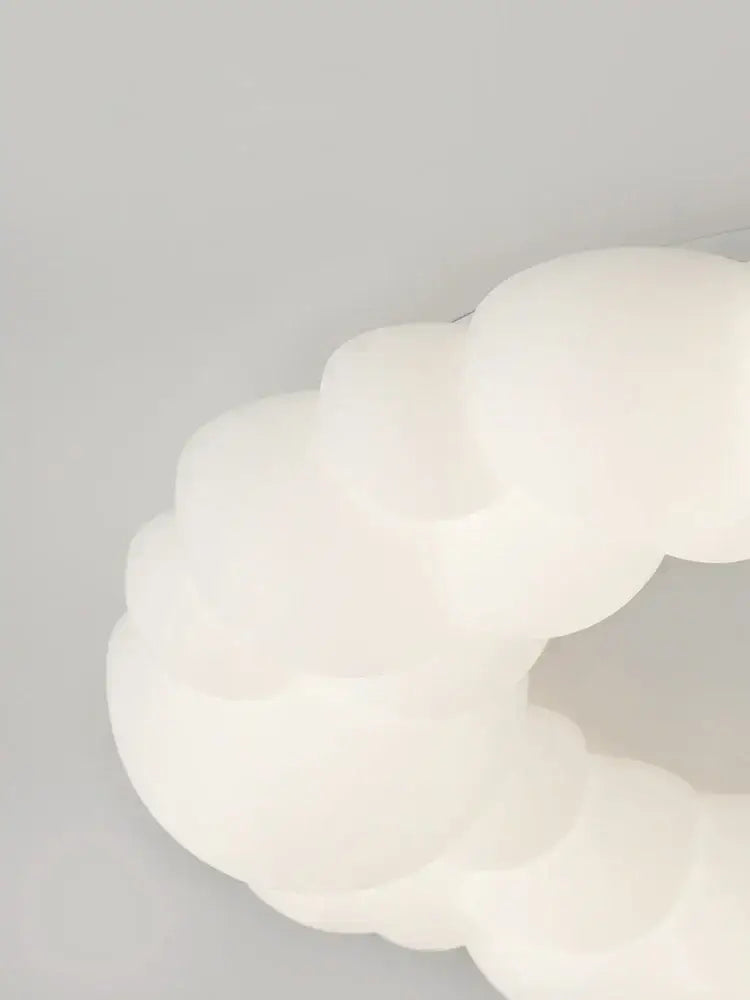 A soft off-white cloud led chandelier with frosted white glass and rounded design by decorbites cloud led for bedroom lighting