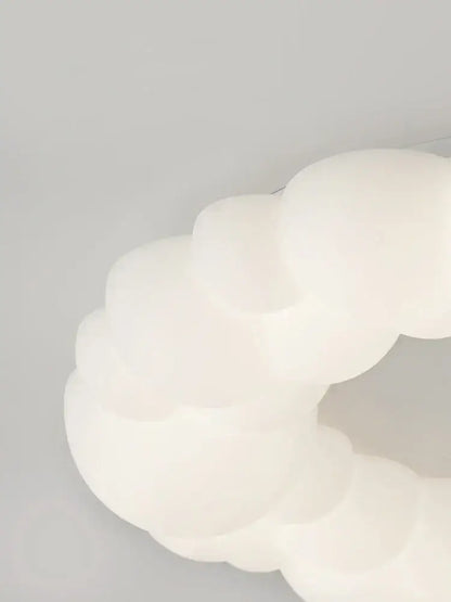 A soft off-white cloud led chandelier with frosted white glass and rounded design by decorbites cloud led for bedroom lighting