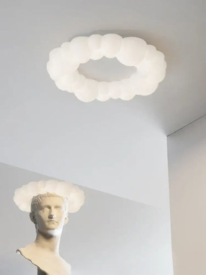 A white frosted glass decorbites cloud led chandelier with a soft rounded design for bedroom lighting