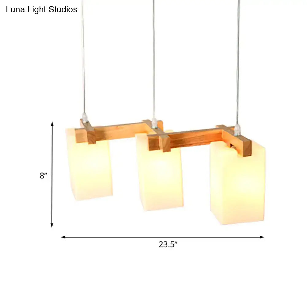 DecorBites™ cluster pendant kitchen lamp featuring modern design with three warm-toned white glass shades and wood frame