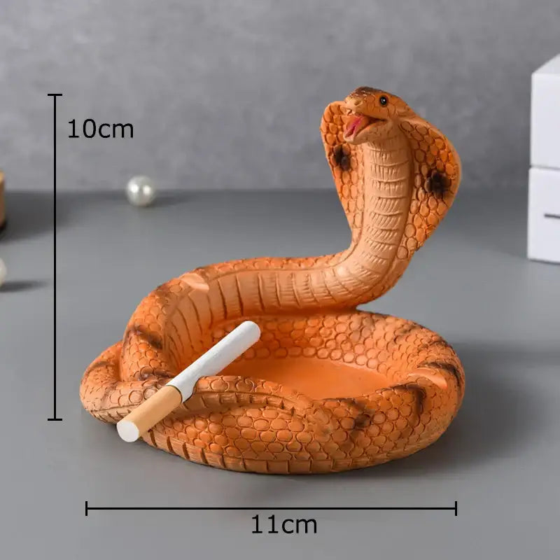 Orange decorbites cobra ashtray in resin with detailed scales and dark brown markings for office smoking accessory use