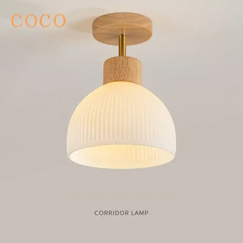 A cream-colored ribbed glass dome ceiling chandelier with brass stem and wooden disc by decorbites coco wood glass