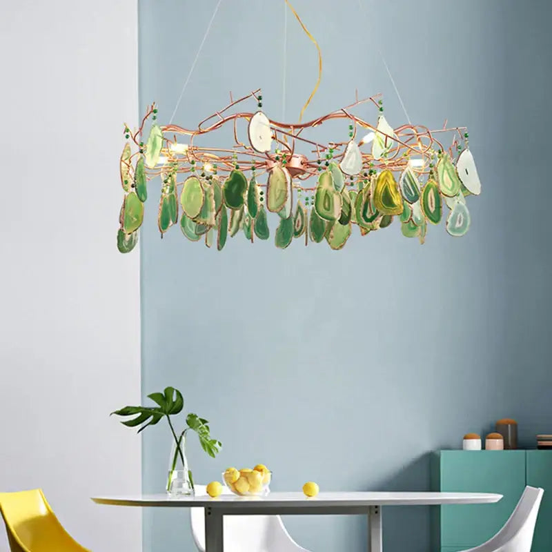 A decorbites colorful agate chandelier featuring copper branches with green and white translucent agate slices for dining room