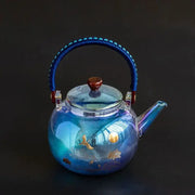 Translucent blue colorful enamel glass crane teapot by decorbites with gold-leaf lotus design and braided handle