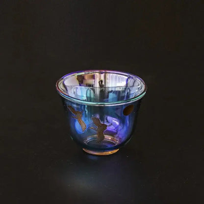 Iridescent blue glass teacup with delicate gold crane illustrations from decorbites colorful enamel glass collection
