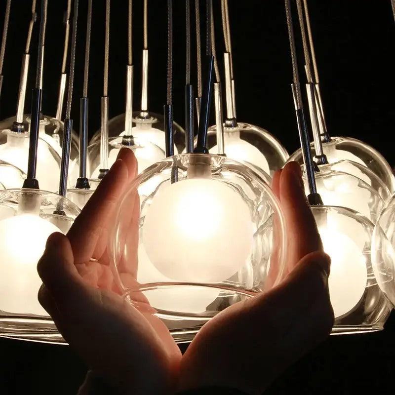 A decorbites colorful glass pendant light featuring a translucent globe with a warm glowing interior for dining rooms