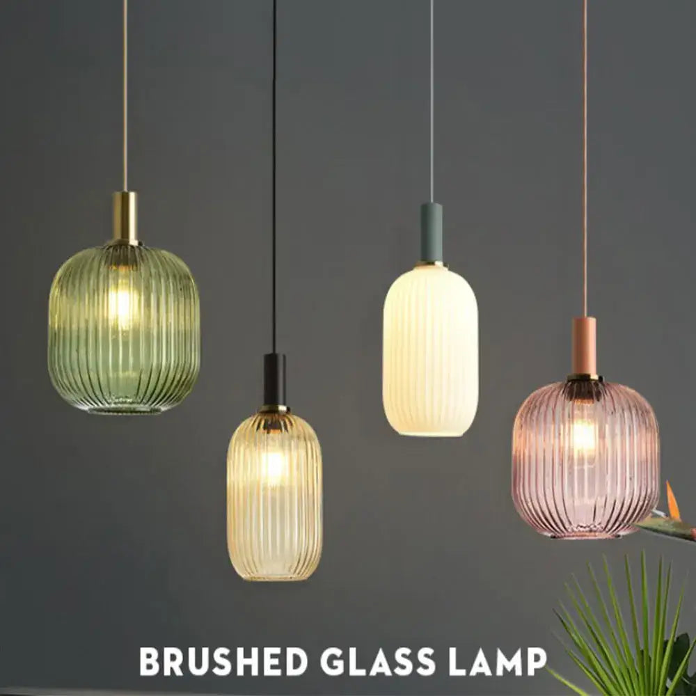 Four colorful glass pendant lights in green amber cream and pink with vertical ribbed textures by DecorBites