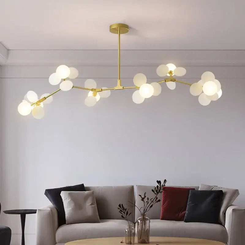 Gold-toned colorful LED branch chandelier with frosted glass globe bulbs for living room and bedroom decor