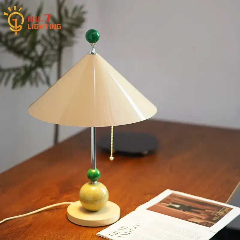 Cream-colored conical lampshade table lamp with green jade beads on metallic stem and yellow ceramic base by decorbites colorful led umbrella