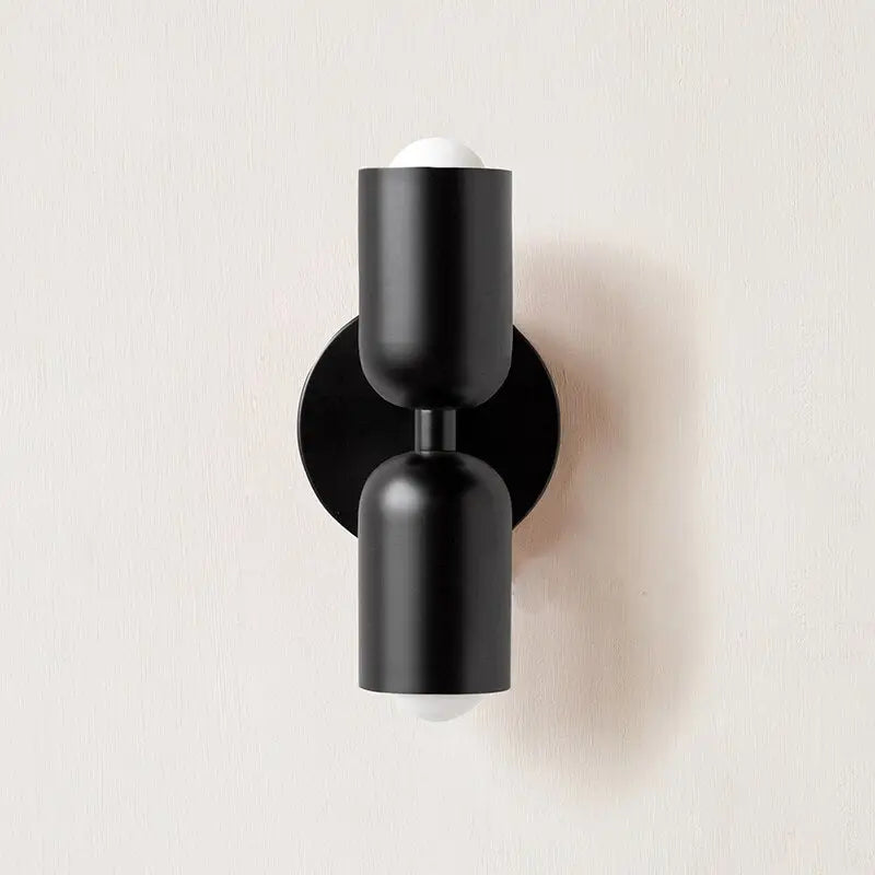 DecorBites colorful modern wall sconce with black matte finish, two glass cylindrical shades, and circular backplate