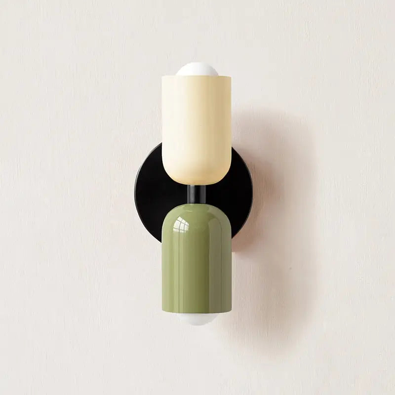Modern wall sconce decorbites with a matte olive green lower cylinder glass shade and creamy off-white upper cylinder design