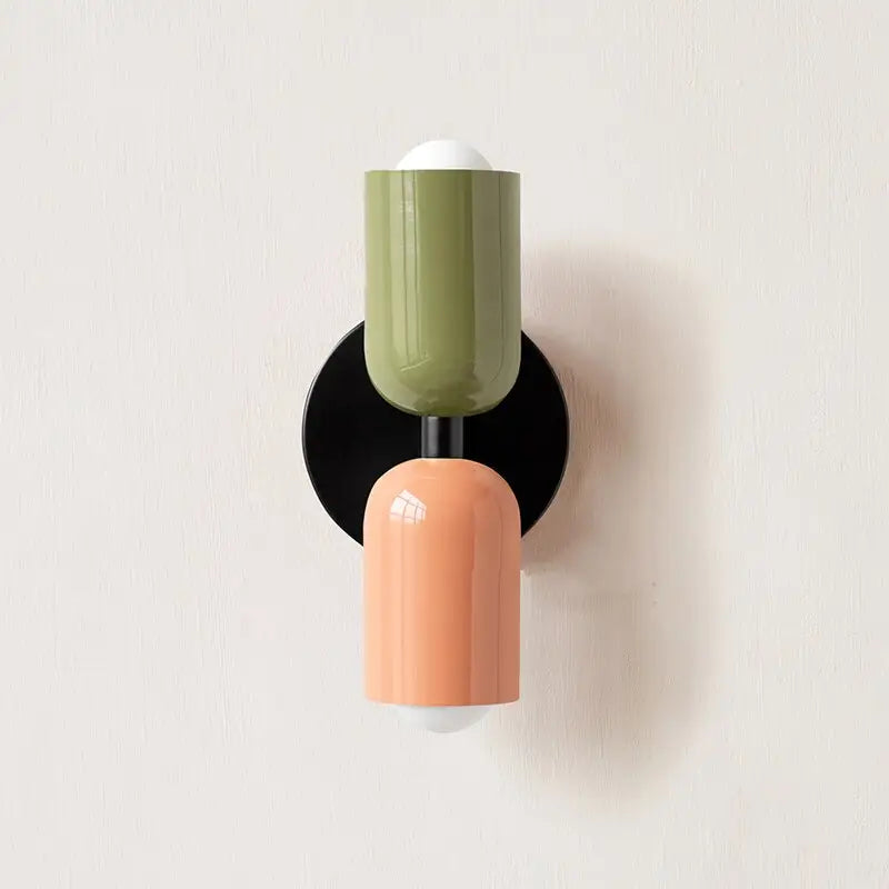 DecorBites™ modern wall sconce with olive green and peach glass shades on a black circular base