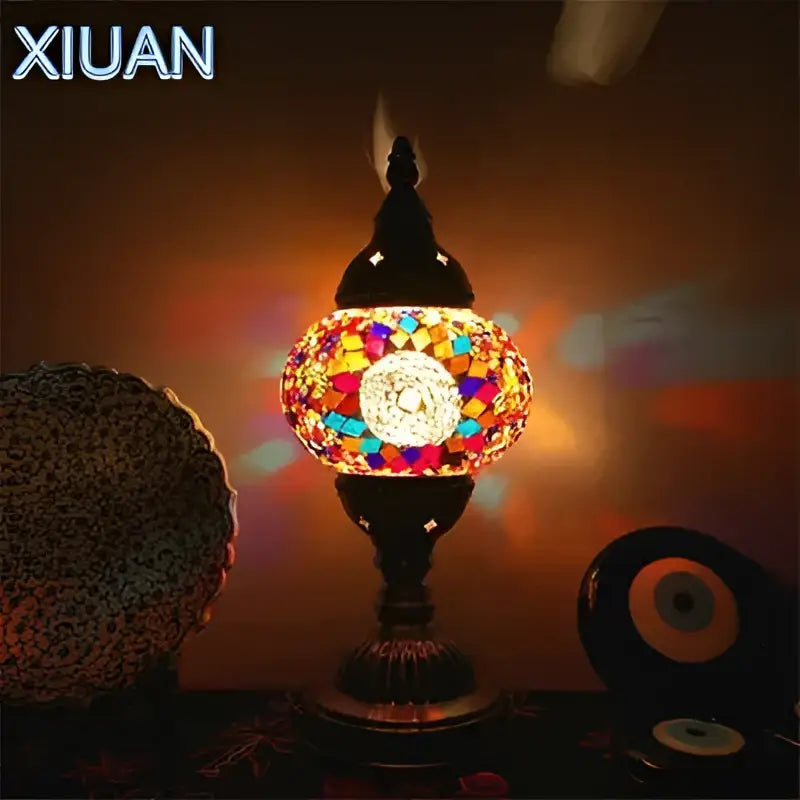 Decorbites colorful mosaic table lamp with vibrant mosaic tiles, black metal base, and ornate brass stained glass top