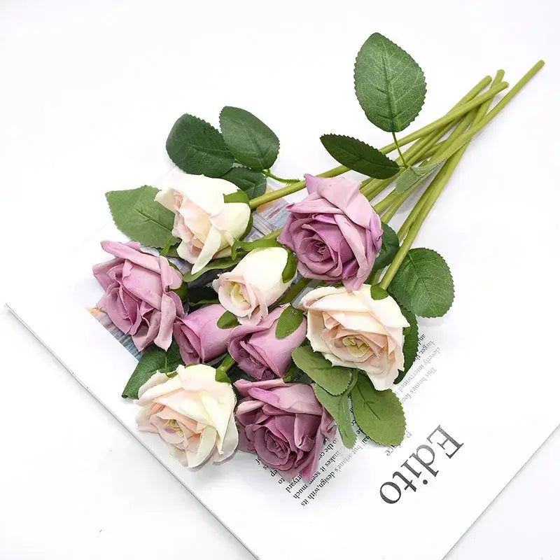 A colorful plastic flower vase by decorbites featuring soft lavender and cream artificial roses with green leaves for home décor