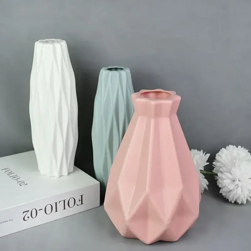 Pink geometric ceramic flower vase with faceted angular design for modern colorful plastic flower home décor