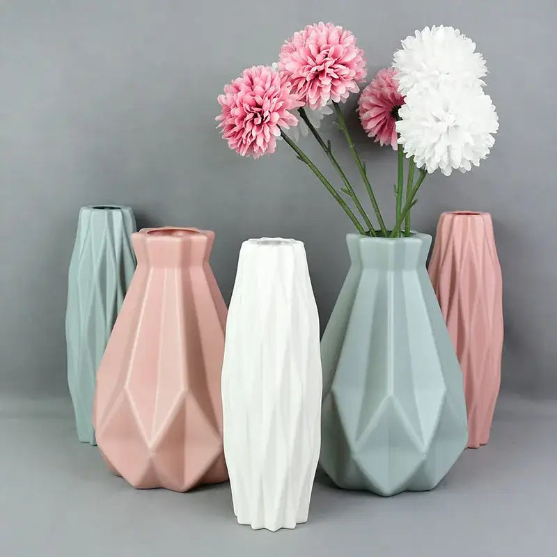 Set of five geometric ceramic flower vases in pastel pink mint green and white for modern colorful plastic flower décor