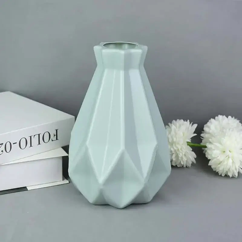 A sleek light mint-green ceramic flower vase with a geometric design for modern home décor by decorbites